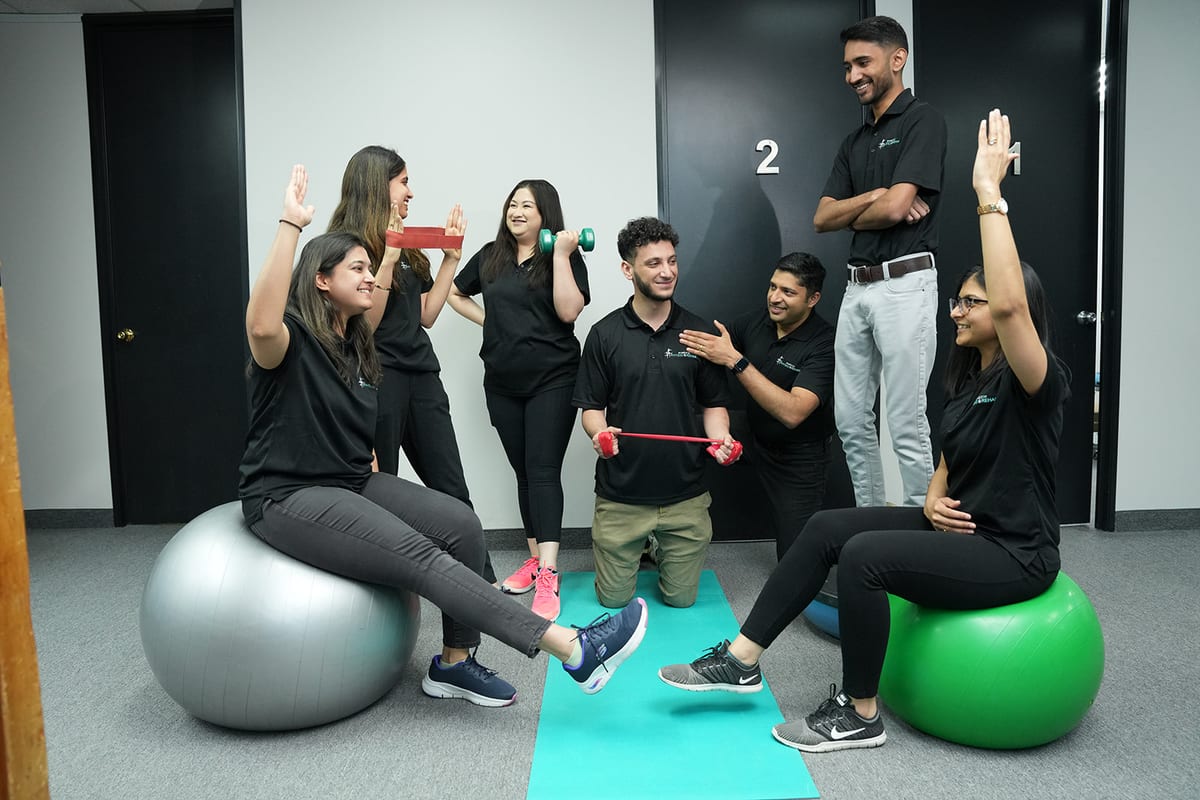 Hamilton Physio & Rehab therapists working through exercises together in the clinic gym